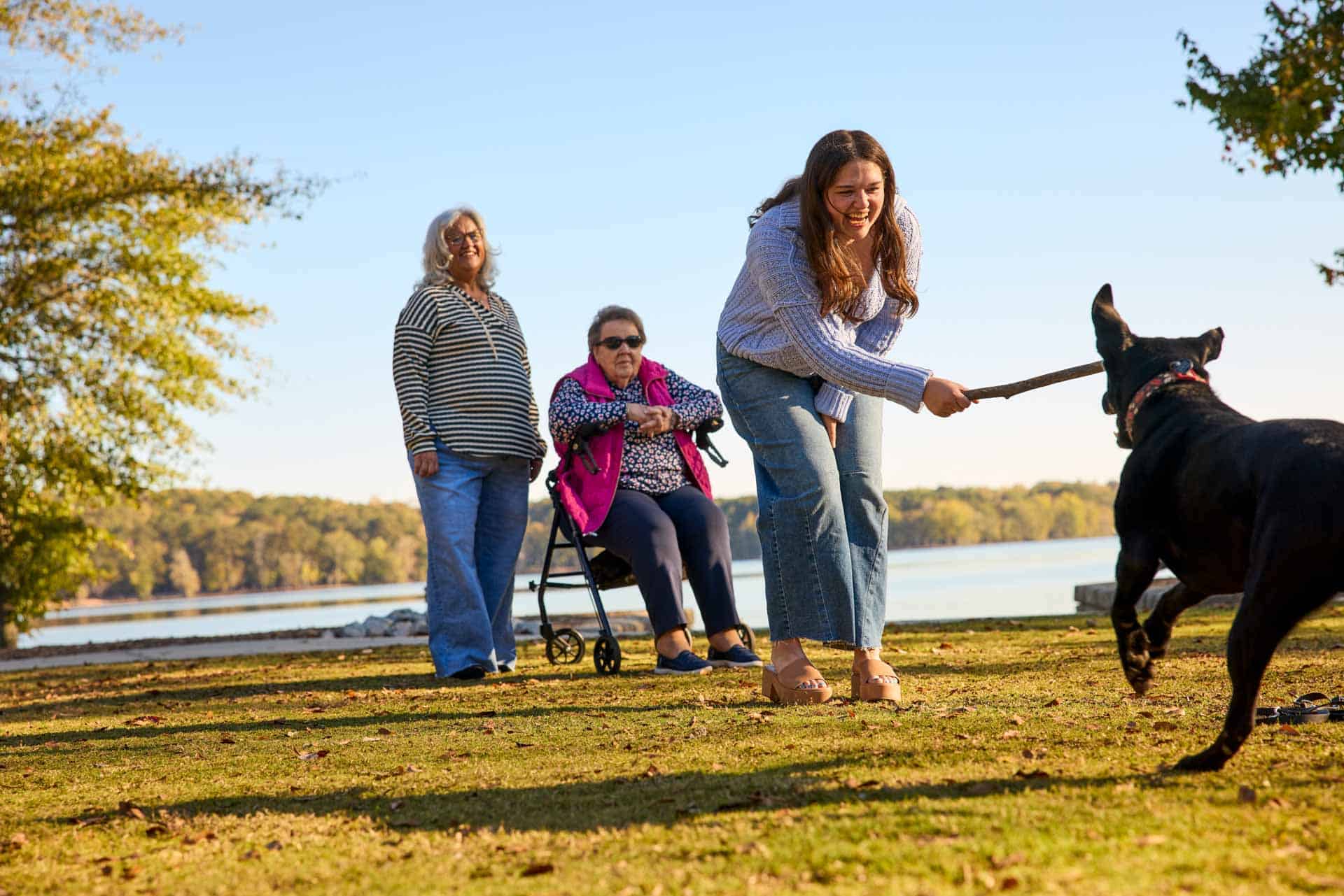 sandwich generation family with dog in park