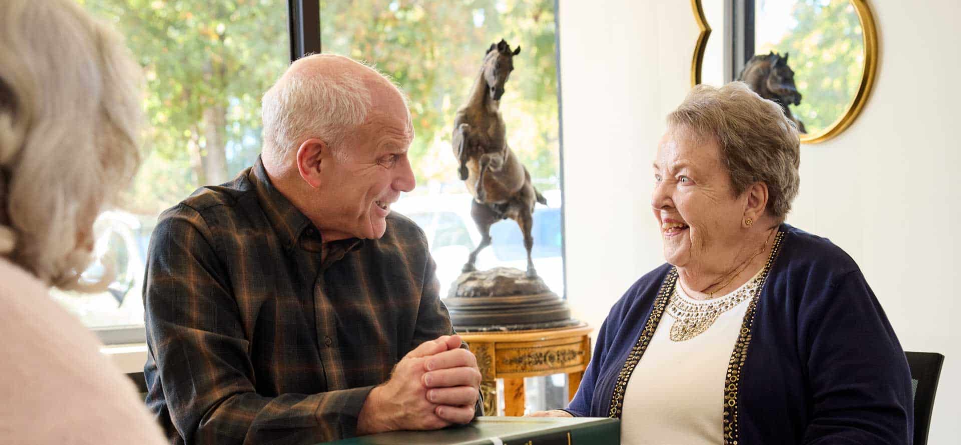Bob Goldberg talking to an elderly woman about estate planning and administration with her daughter who is part of the sandwich generation.