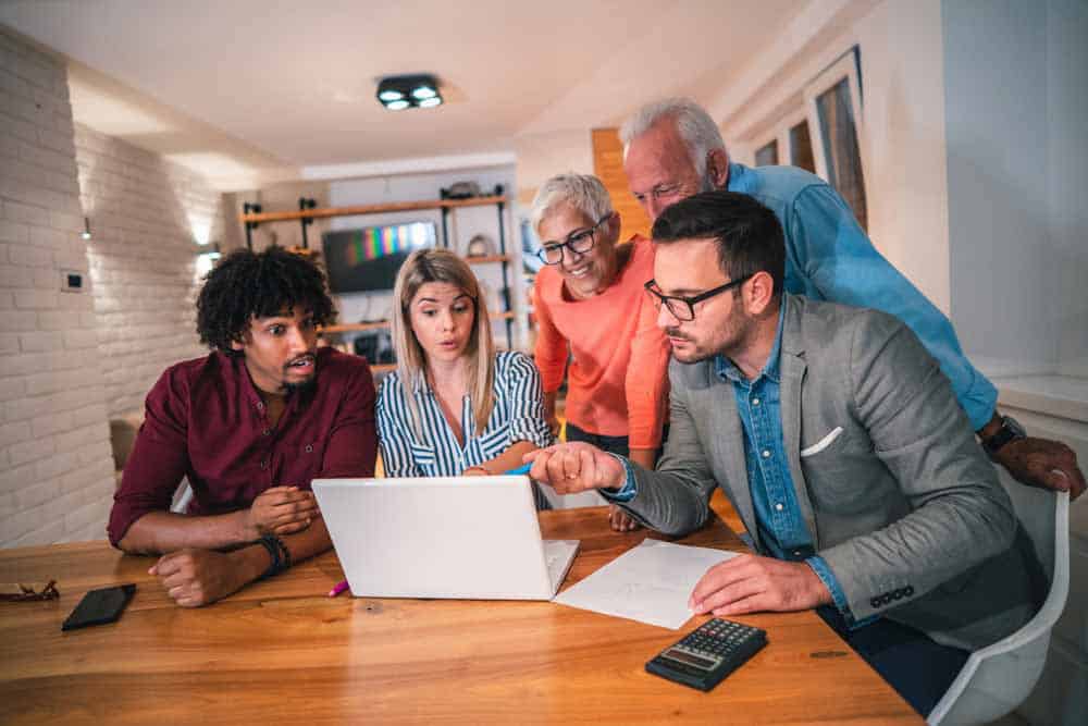 family looking at computer screen together