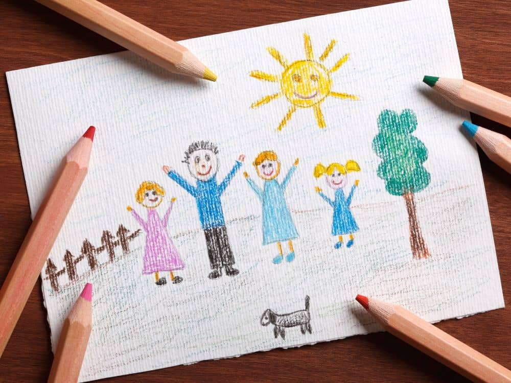 a child's crayon drawing of a happy family